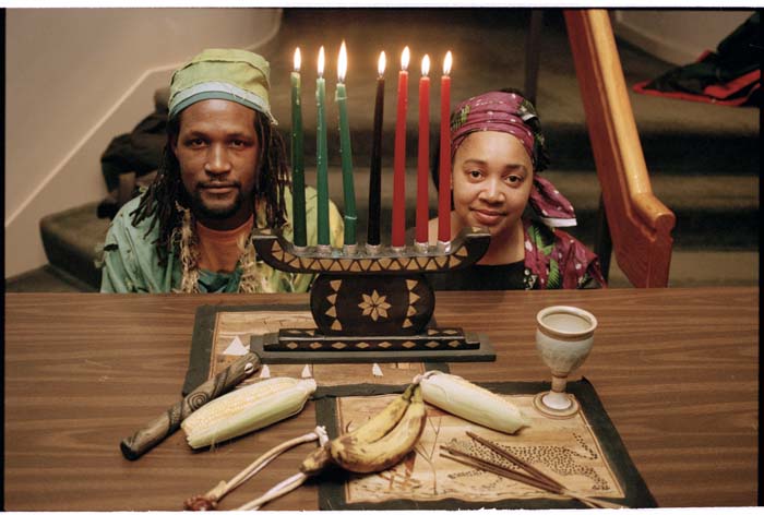 Image of Man and woman with Kwanzaa candles and other symbolic items at Langston Hughes Center, Seattle, December 20, 1996