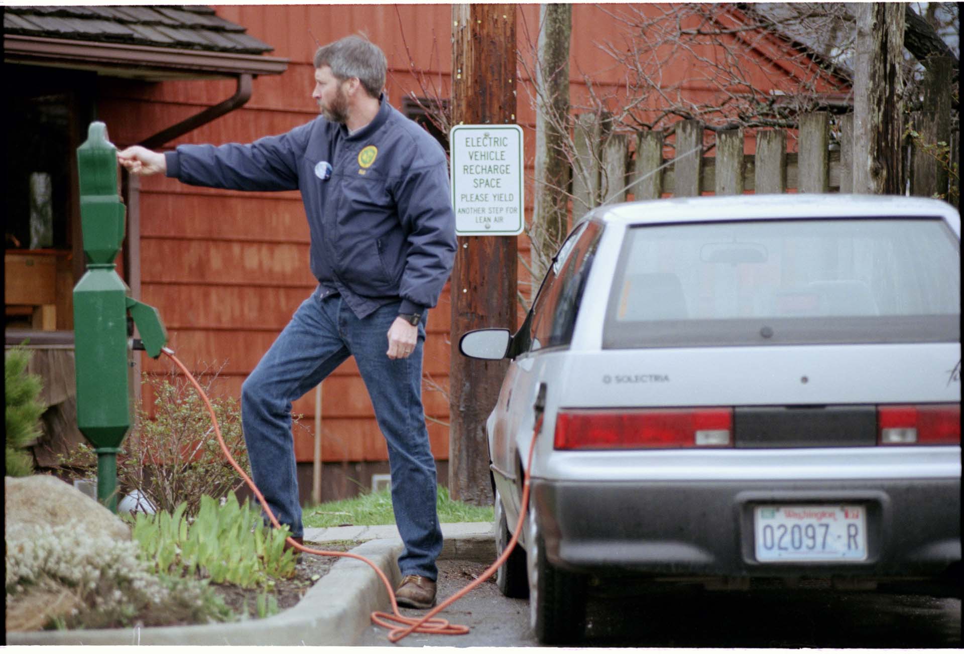 Image of Bill Culliton charging electric car, Orcas Island, March 6, 1997