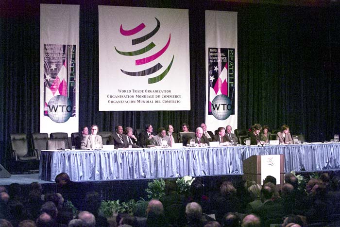 Image of Speakers on dais in front of WTO banners, Seattle, November 30, 1999