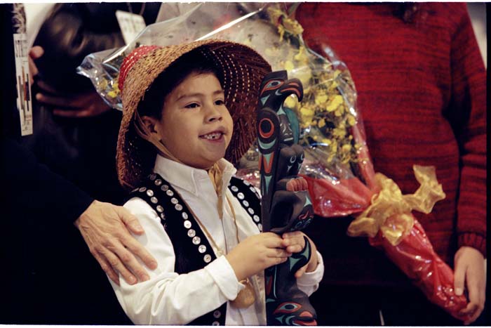 Image of Dustin Williams holding traditional talking stick at Nelson Mandela welcoming ceremony, Seattle, December 8, 1999