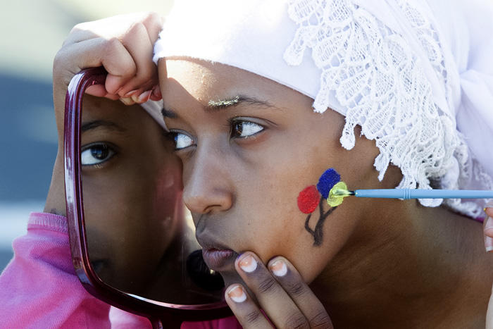 Image of Chaltu Abdela having her face painted at Juneteenth celebration, Seattle, June 19, 2001