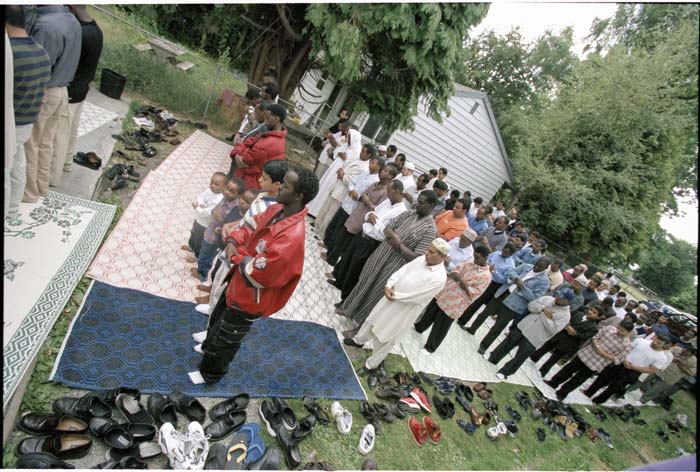 Image of Men standing during worship at the Masjid Al-Salaam, SeaTac, August 3, 2001