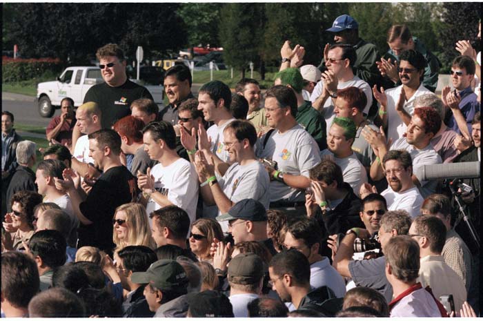 Image of Microsoft programmers applauding completion of Windows XP, Redmond, August 24, 2001