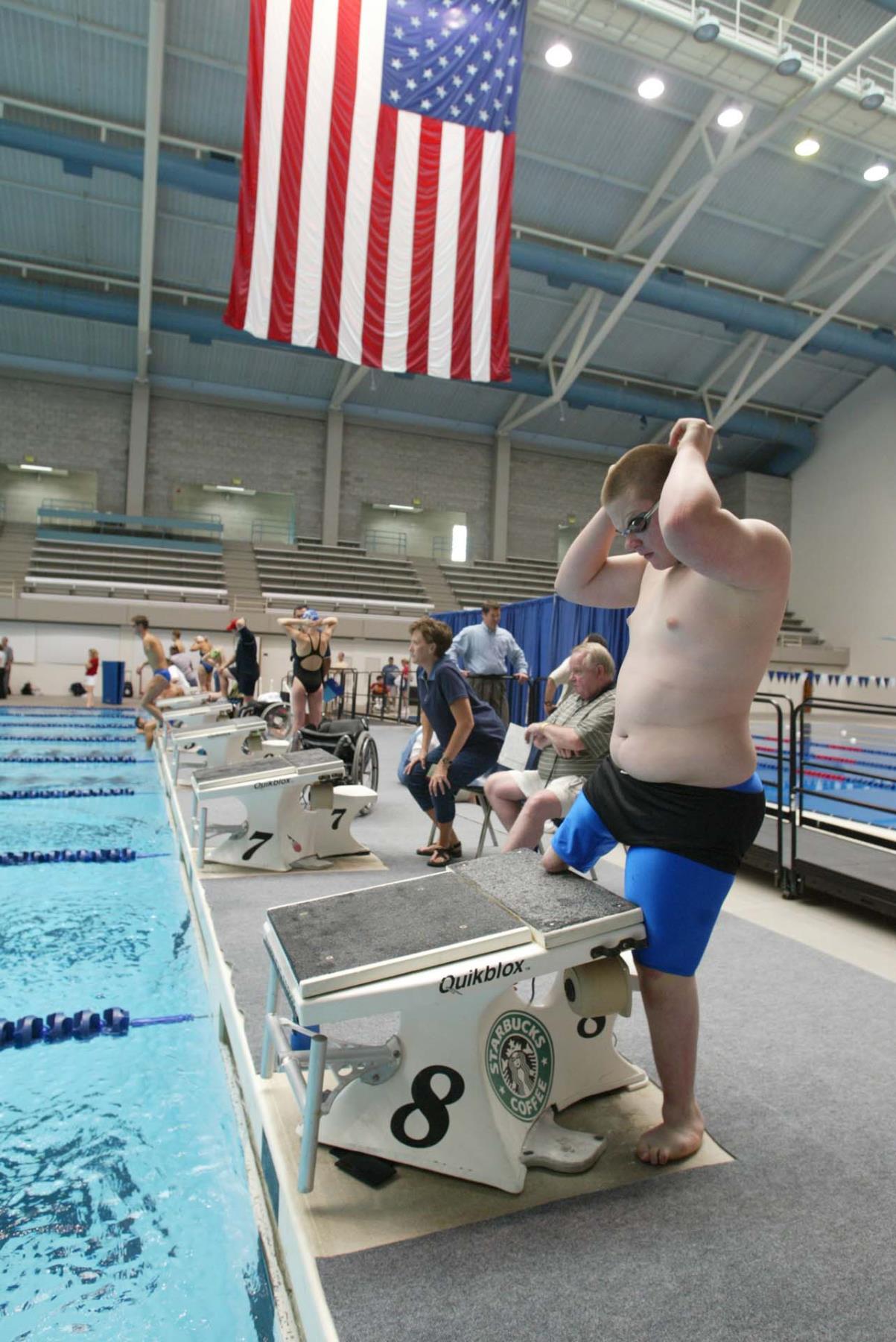 Image of Justin Fleming climbing the starting block at swim practice, Federal Way, June 12, 2002