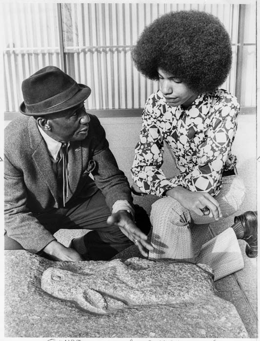 Image of James Washington Jr. explaining his work to Lee Carnett, Seattle, April 1972