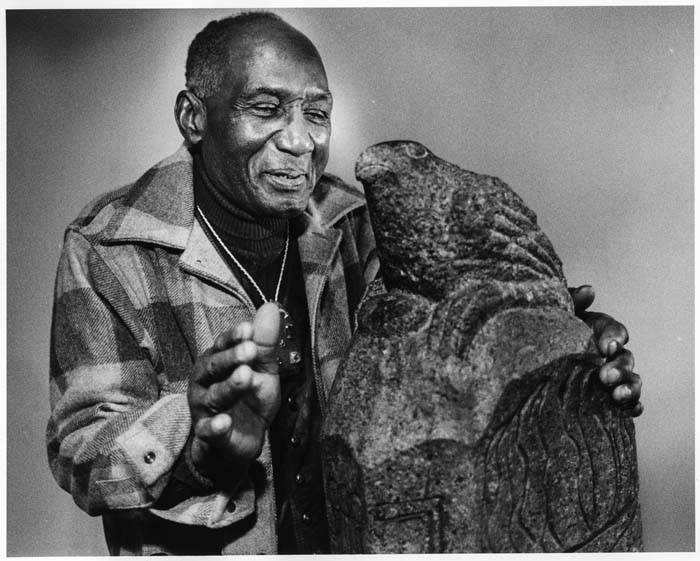 Image of James Washington Jr. with his sculpture 