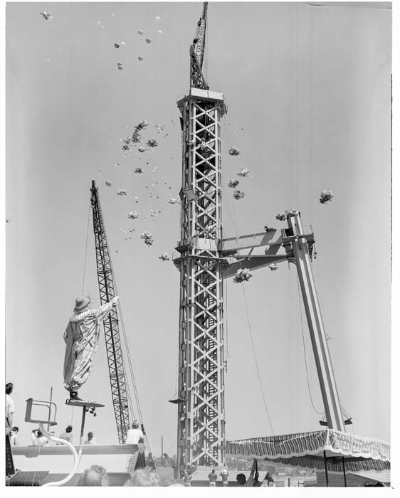 Image of Seafair clown releasing balloons near Space Needle construction site, July 30, 1961