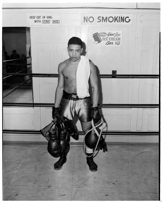 Image of Buford Ransom holding training gear at boxing gym, September 24, 1947