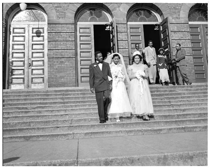 Image of Bride and groom on steps of Immaculate Conception Church, Seattle, circa 1947