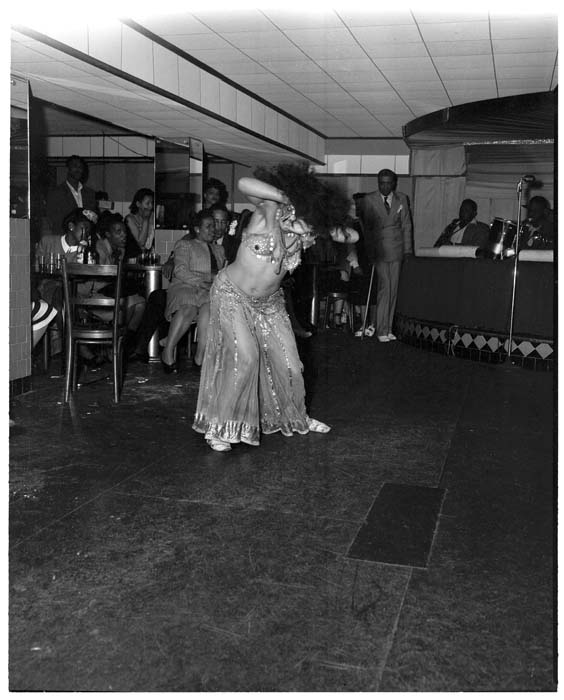 Image of Woman in costume dancing at club,  Seattle, circa 1948