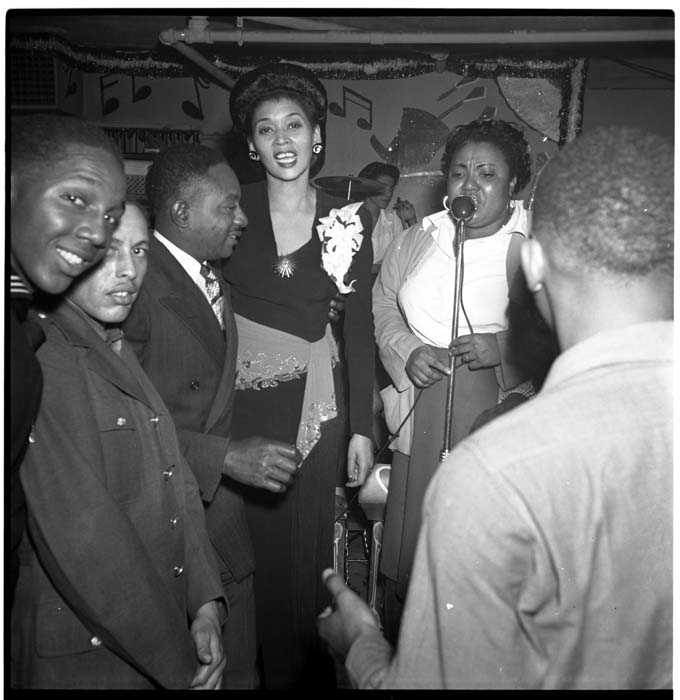 Image of Women singing at microphone at the Black & Tan nightclub, 1944