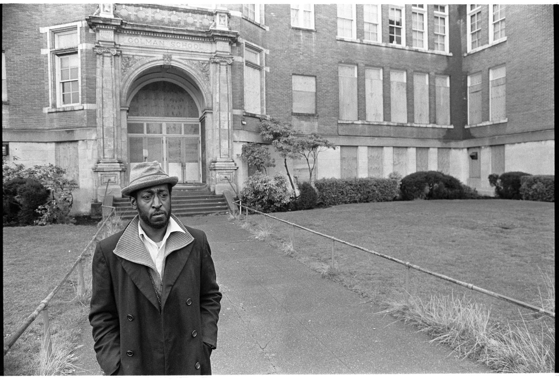 Image of Charlie James in front of Colman School building, Seattle, December  5, 1985