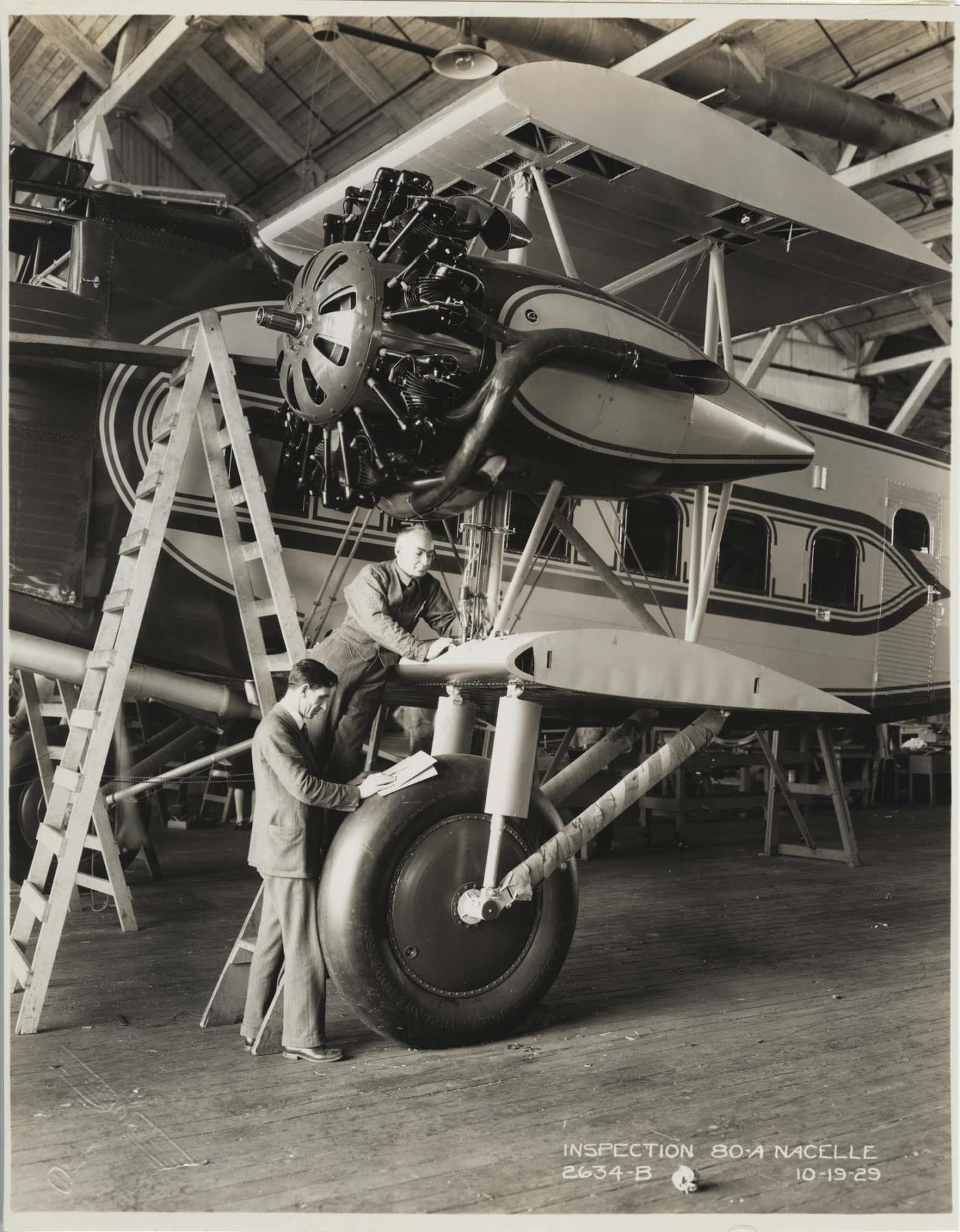Image of Inspectors examining a Boeing Model 80-A plane at the Boeing factory, Seattle, October 19, 1929