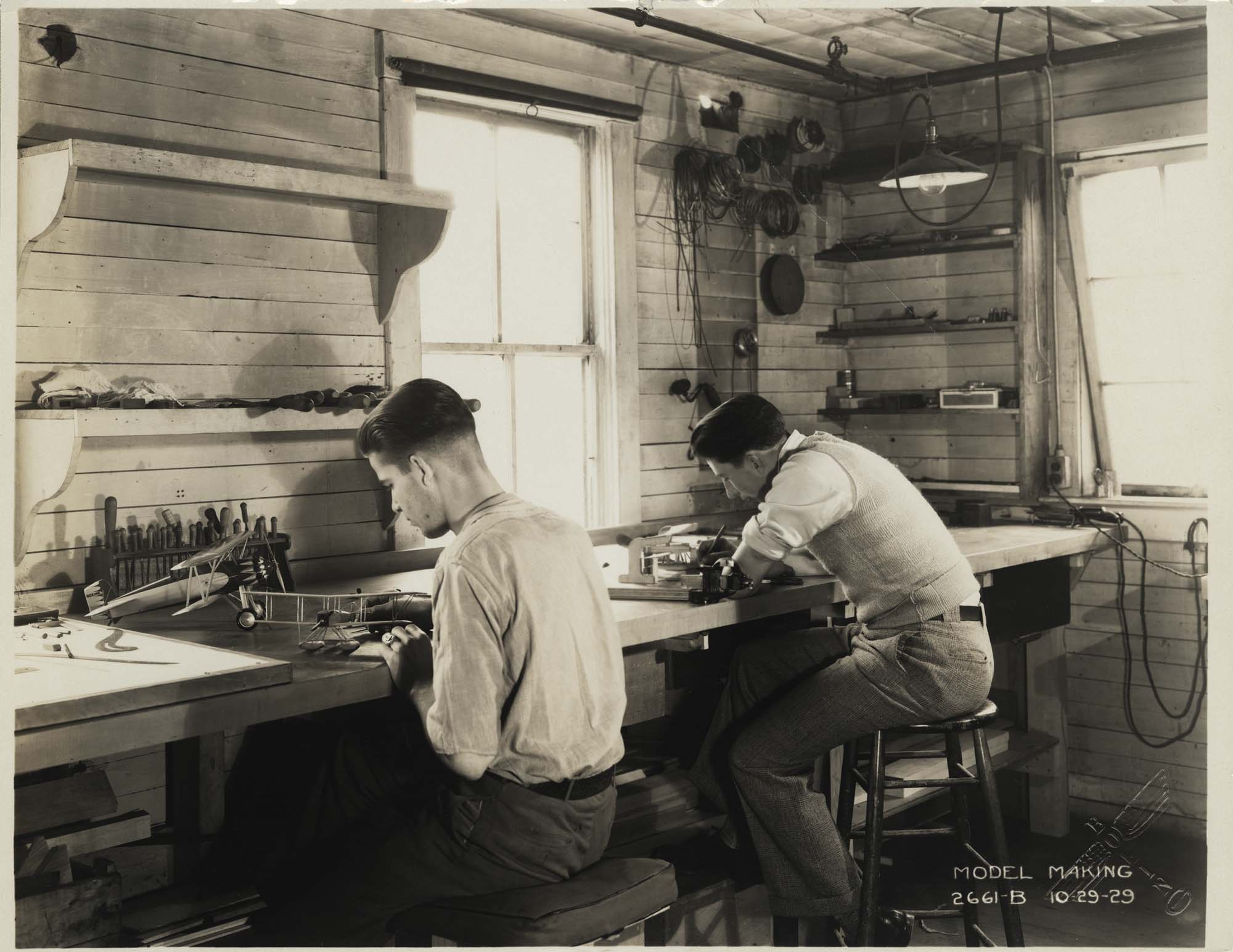 Image of Two men working on hydroplane models in Boeing’s model making shop, October 29, 1929