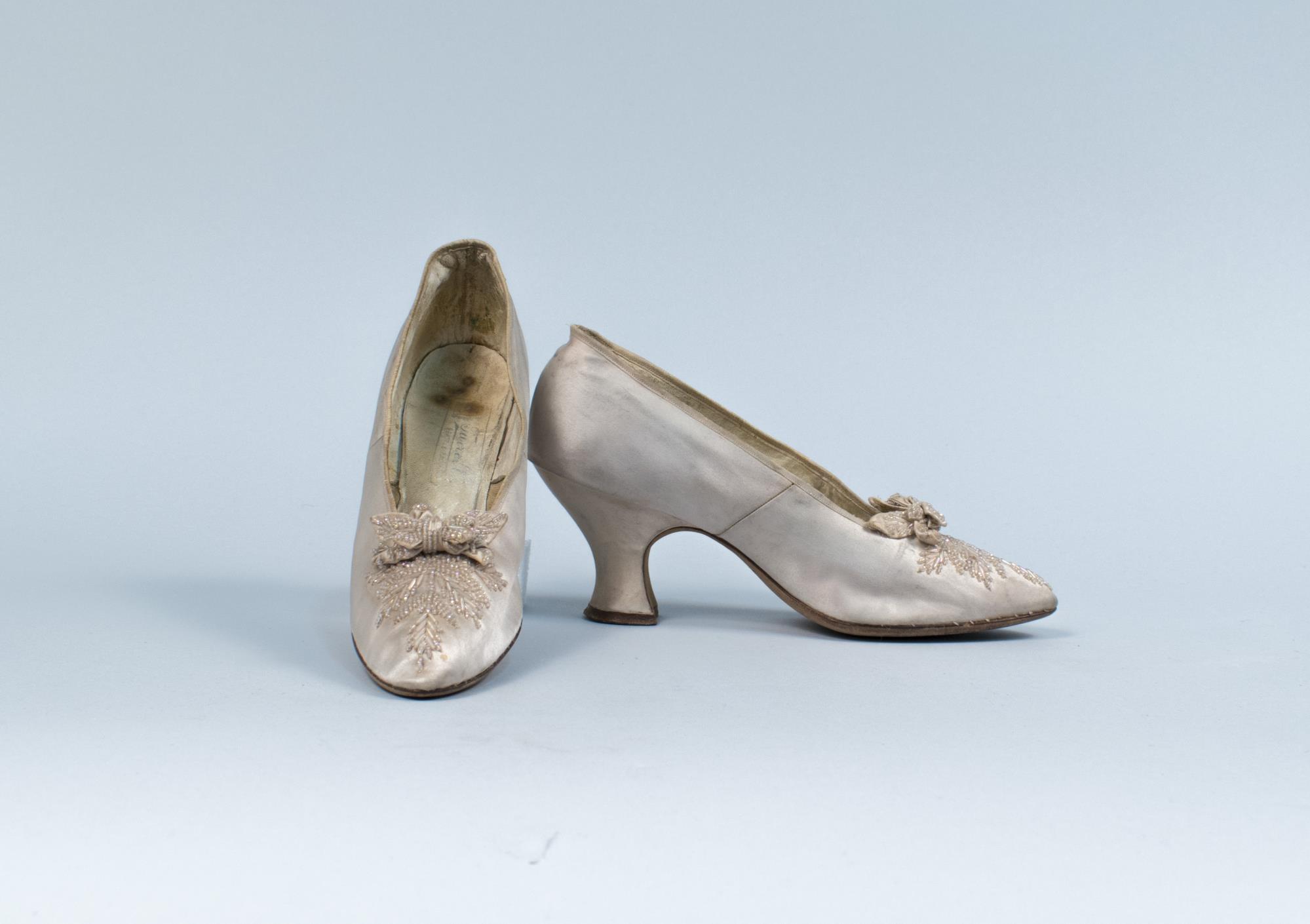Image of Pink satin slippers with beading and bows, ca. 1910