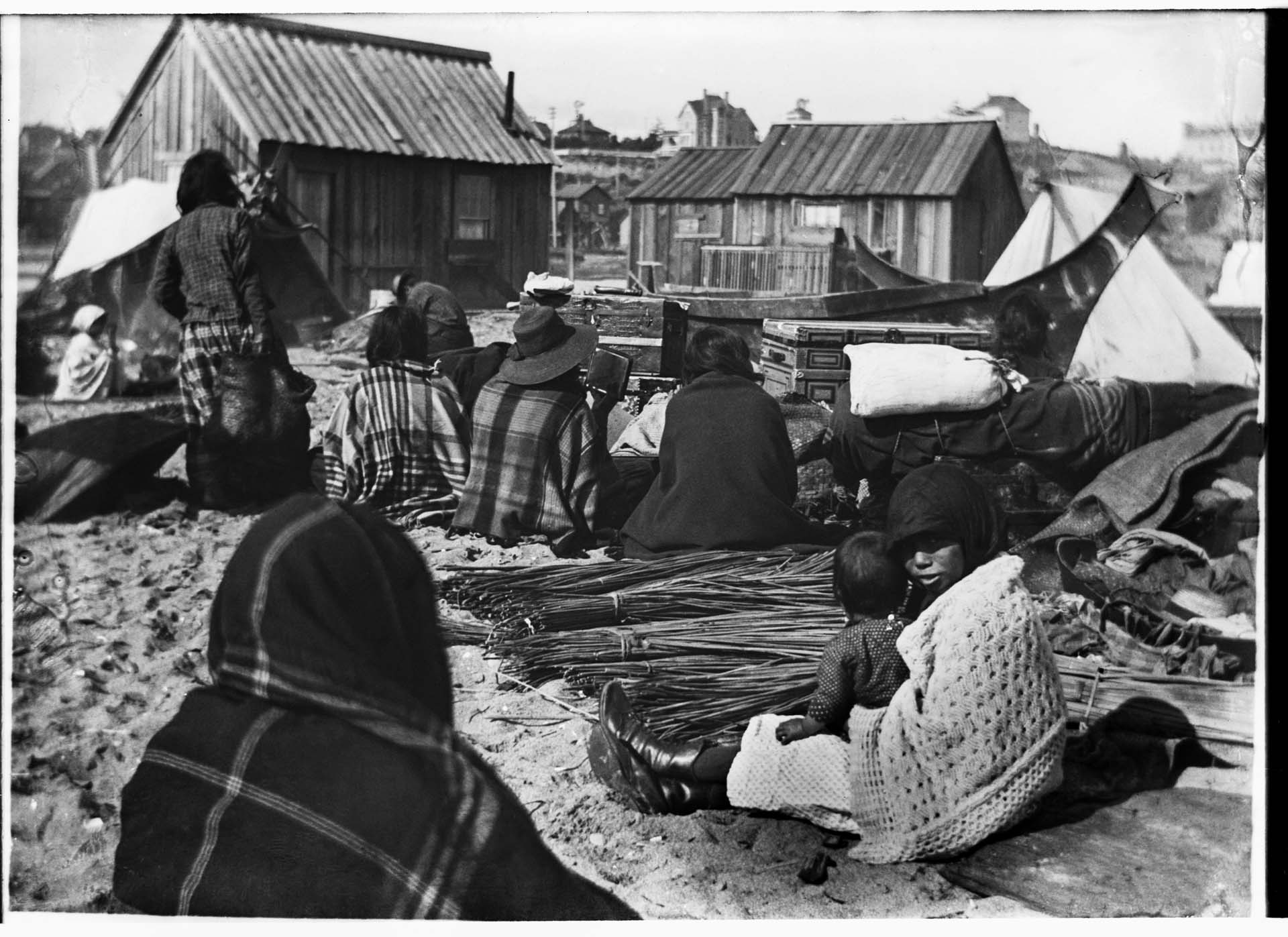 Image of Group seated on the beach with trade items, Port Townsend, circa 1900