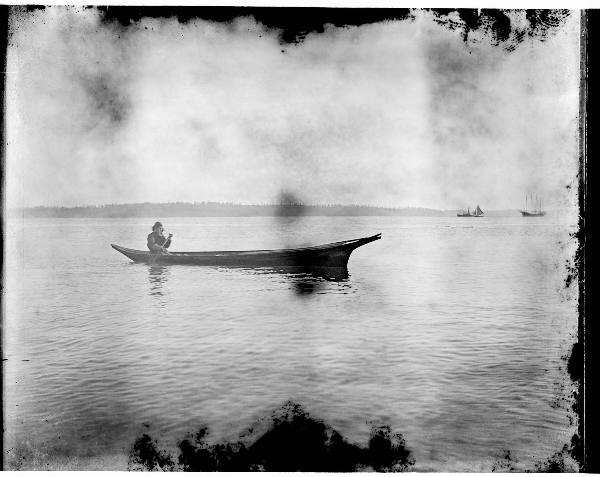 Image of Coast Salish canoe in Port Townsend Bay, circa 1900