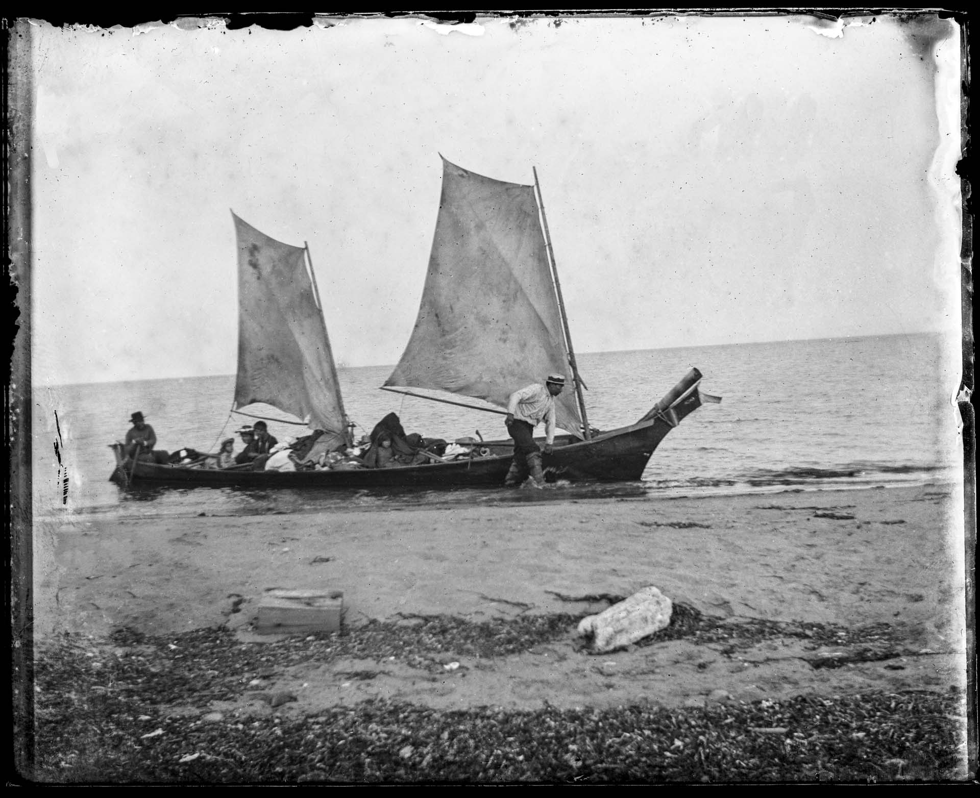 Image of West Coast style canoe with two sails, circa 1900