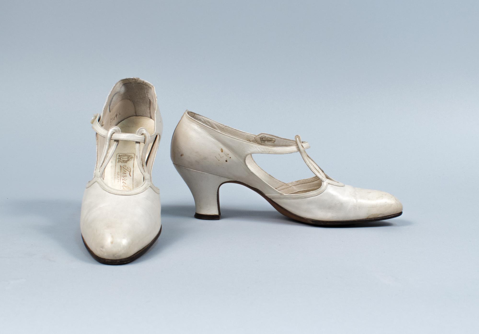 Image of White kid leather shoes with strap through two loops, ca. 1924