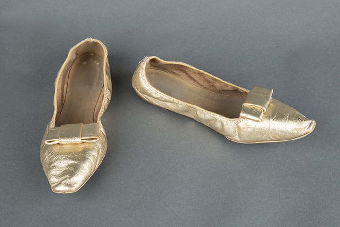 Image of Pair of gold leather slippers, worn as part of Century 21 Seattle World's Fair Fashion Show, 1962