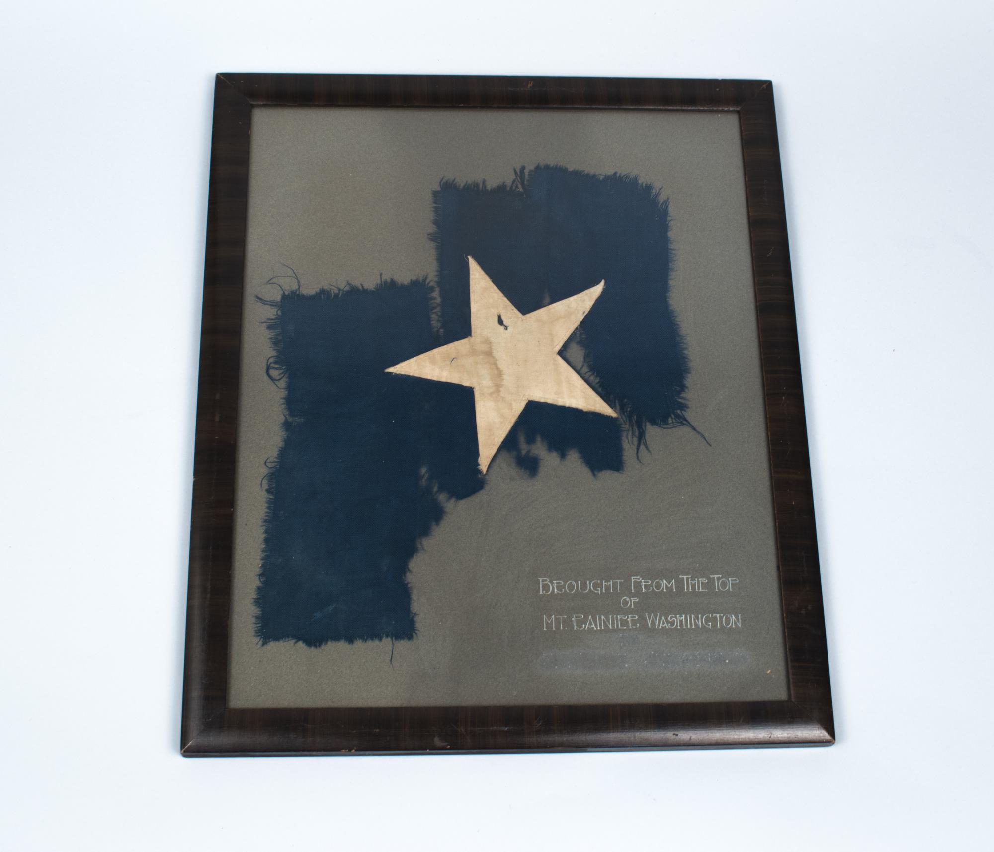 Image of Framed portion of flag carried to the top of Mt. Rainier on July 20, 1894, by a Seattle group led by Major Ingraham