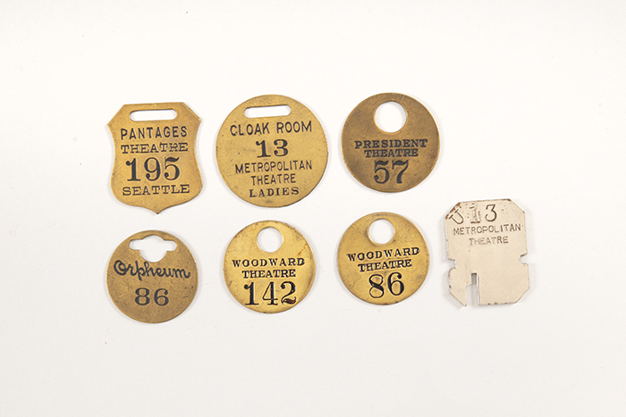 Image of Collection of theater coat check tags, ca. 1900-1950