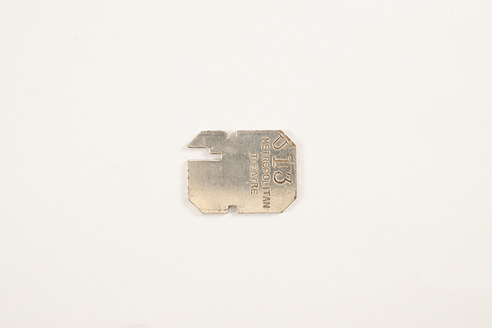 Image of Collection of theater coat check tags, ca. 1900-1950