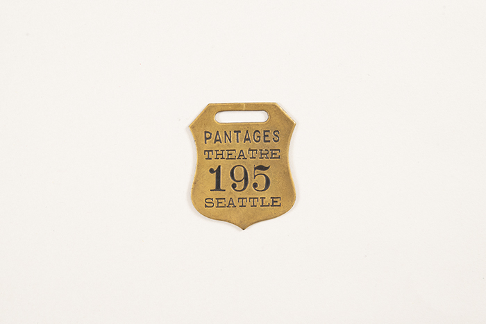 Image of Collection of theater coat check tags, ca. 1900-1950