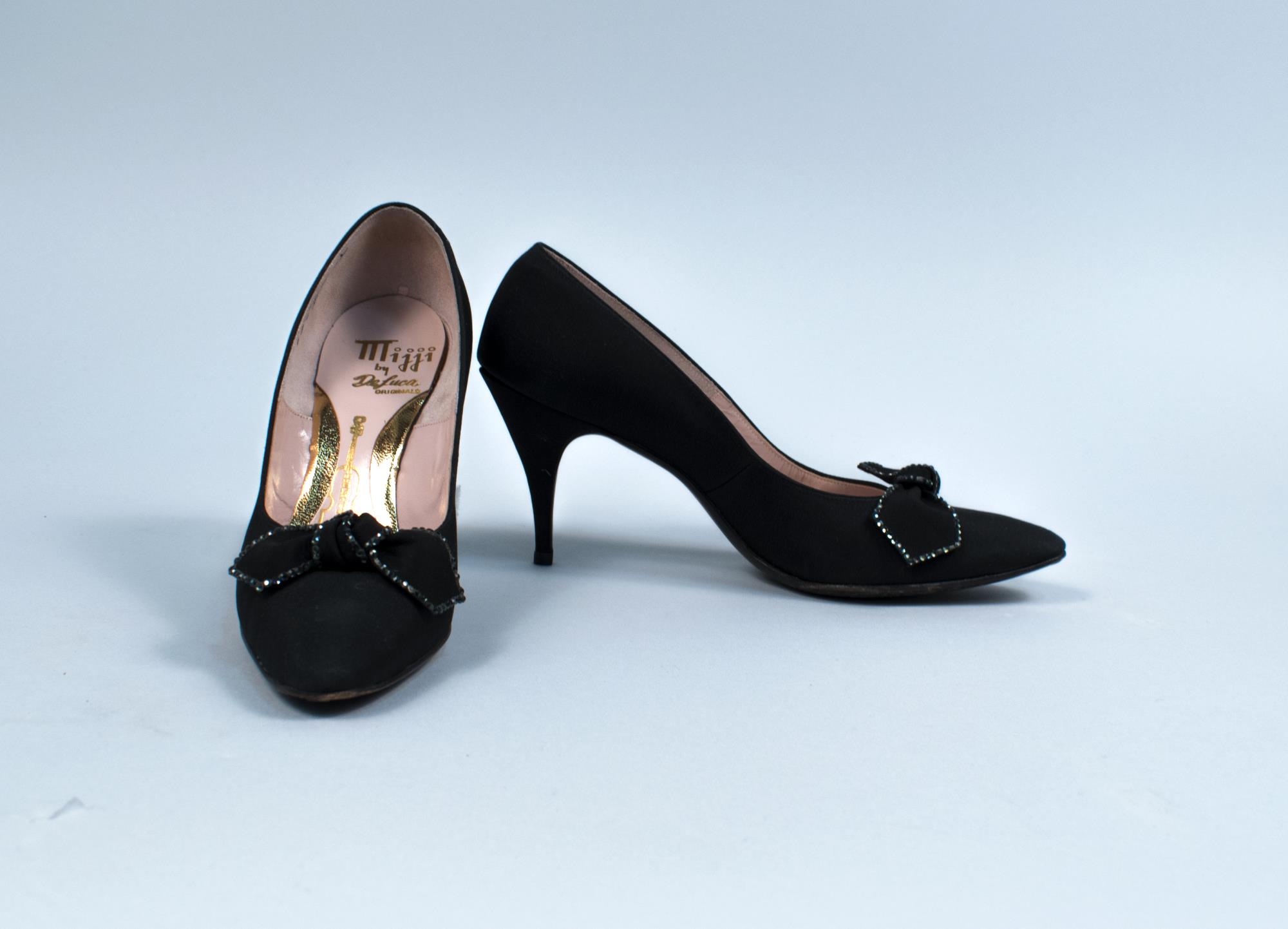 Image of Black high heels with black bows, ca. 1950s