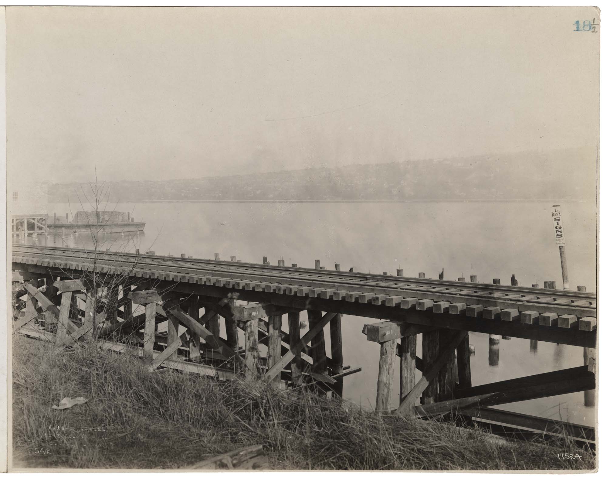 Image of Northern Pacific trestle along shore of Lake Union, showing frontage owned by Pacific Coast Coal Co., Seattle, circa 1915