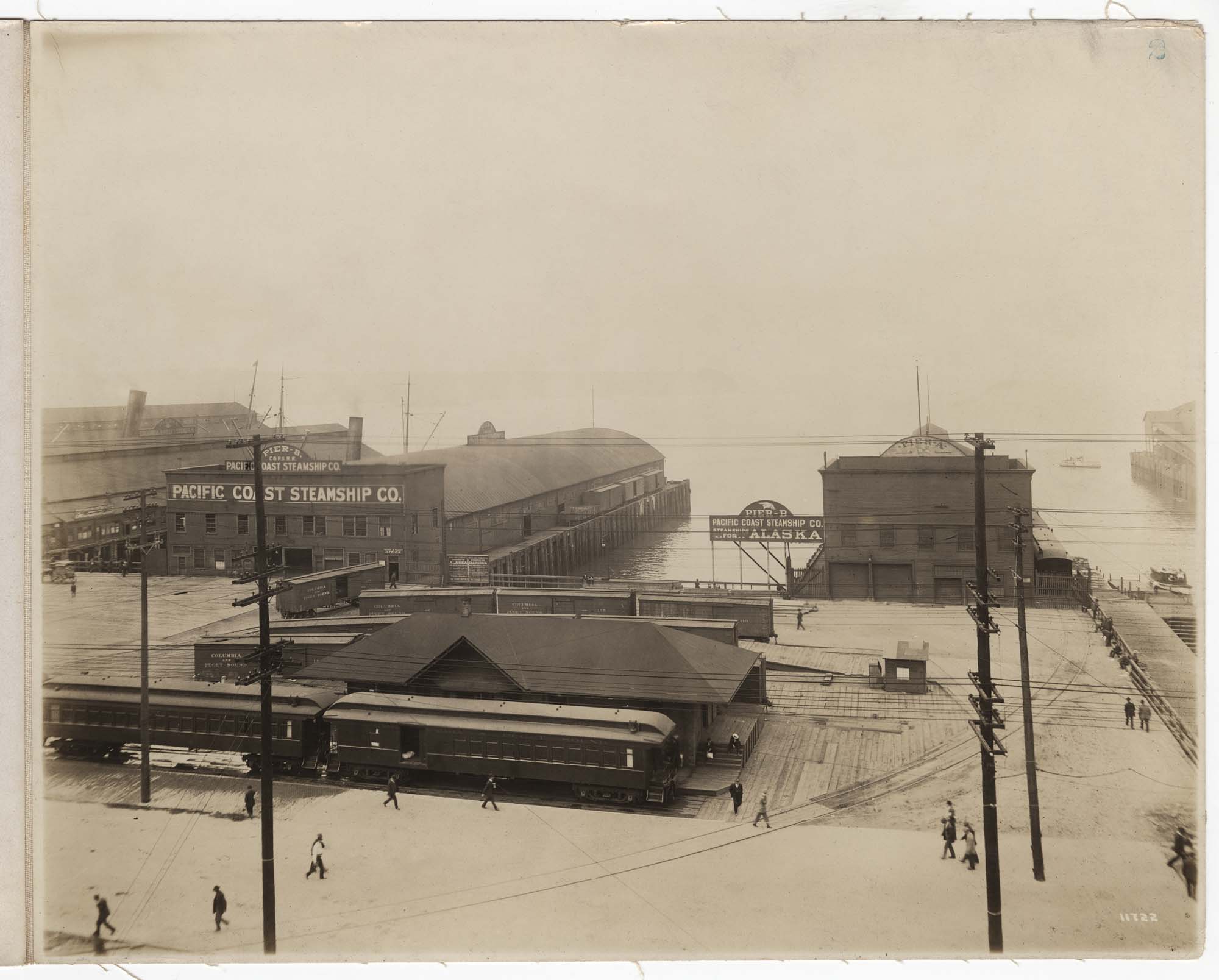 Image of Pacific Coast Steamship Company piers with Columbia & Puget Sound Railroad passenger depot and team tracks, Seattle, circa 1904