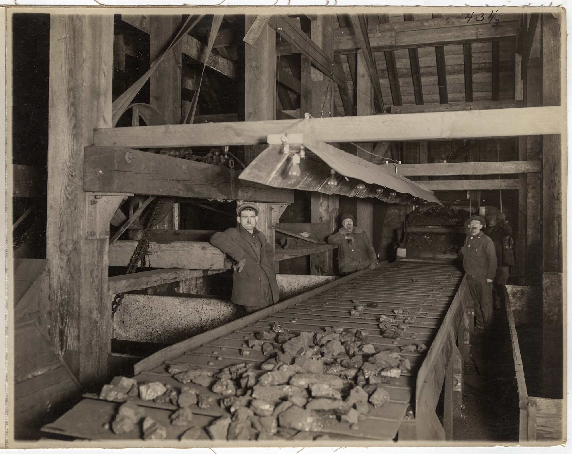 Image of Men at picking table at Cannon Mine bunkers, Franklin, circa 1915