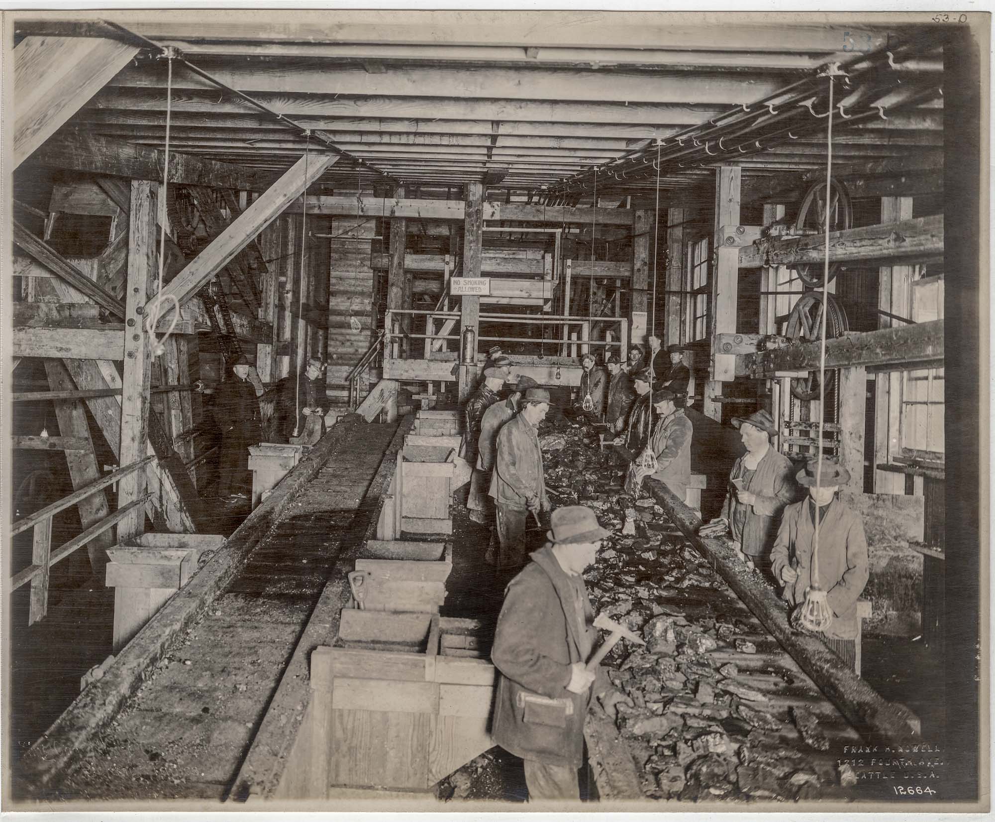 Image of Men working at picking table at Issaquah mine, circa 1913