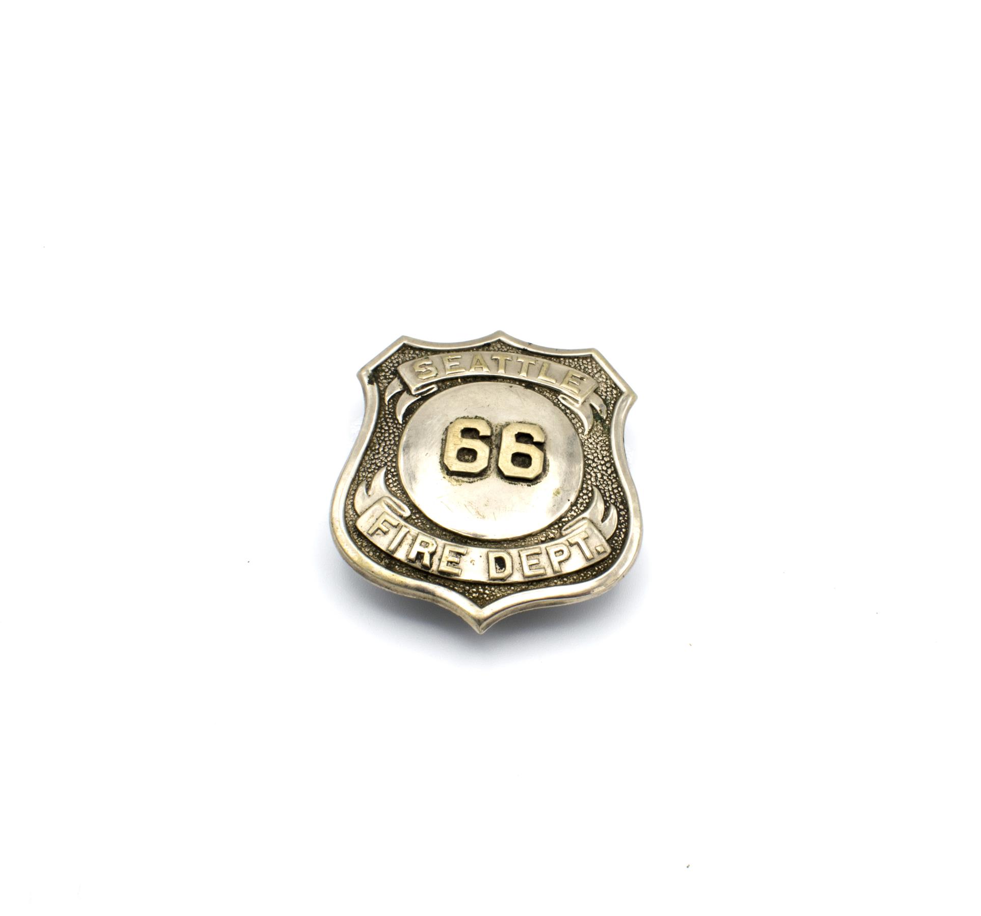 Image of Seattle Fire Department badge no. 66, ca. 1900