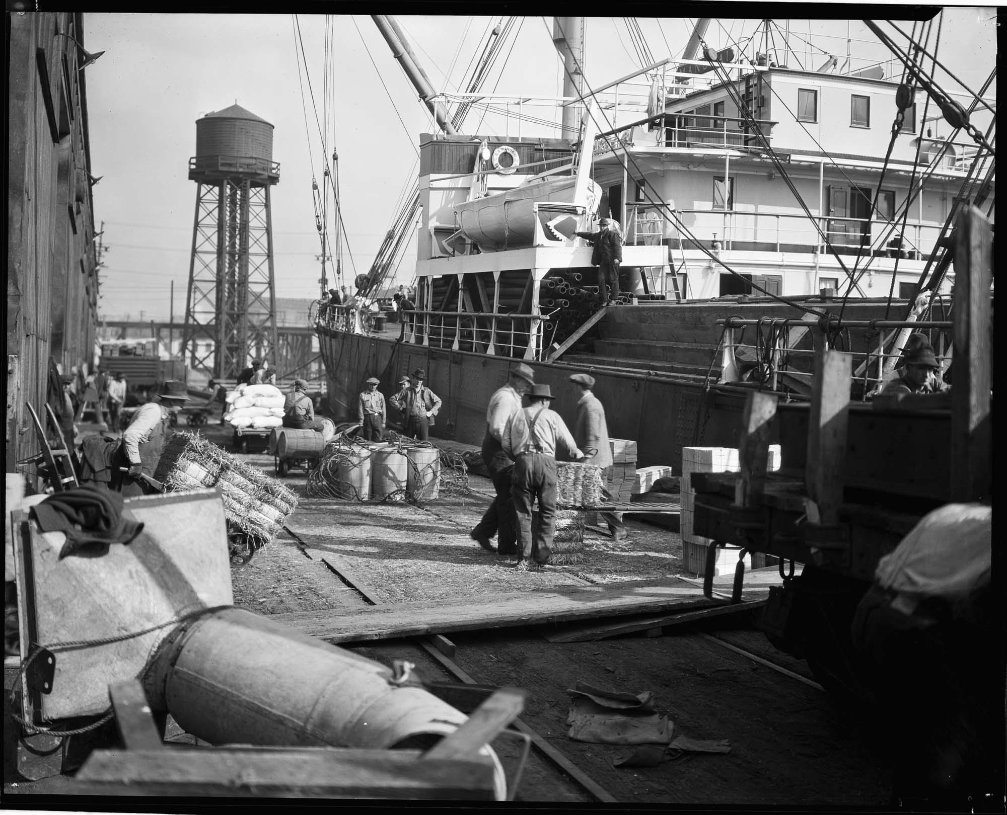 Image of Longshoremen transferring cargo at dockside, circa 1925