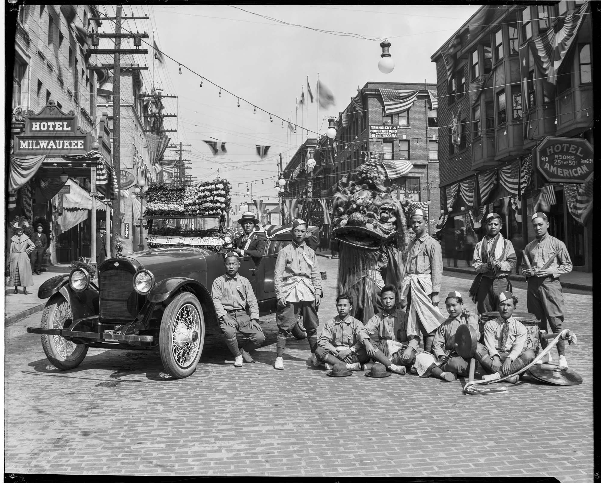 Image of Chinese dance group with decorated car on King Street, May 1921