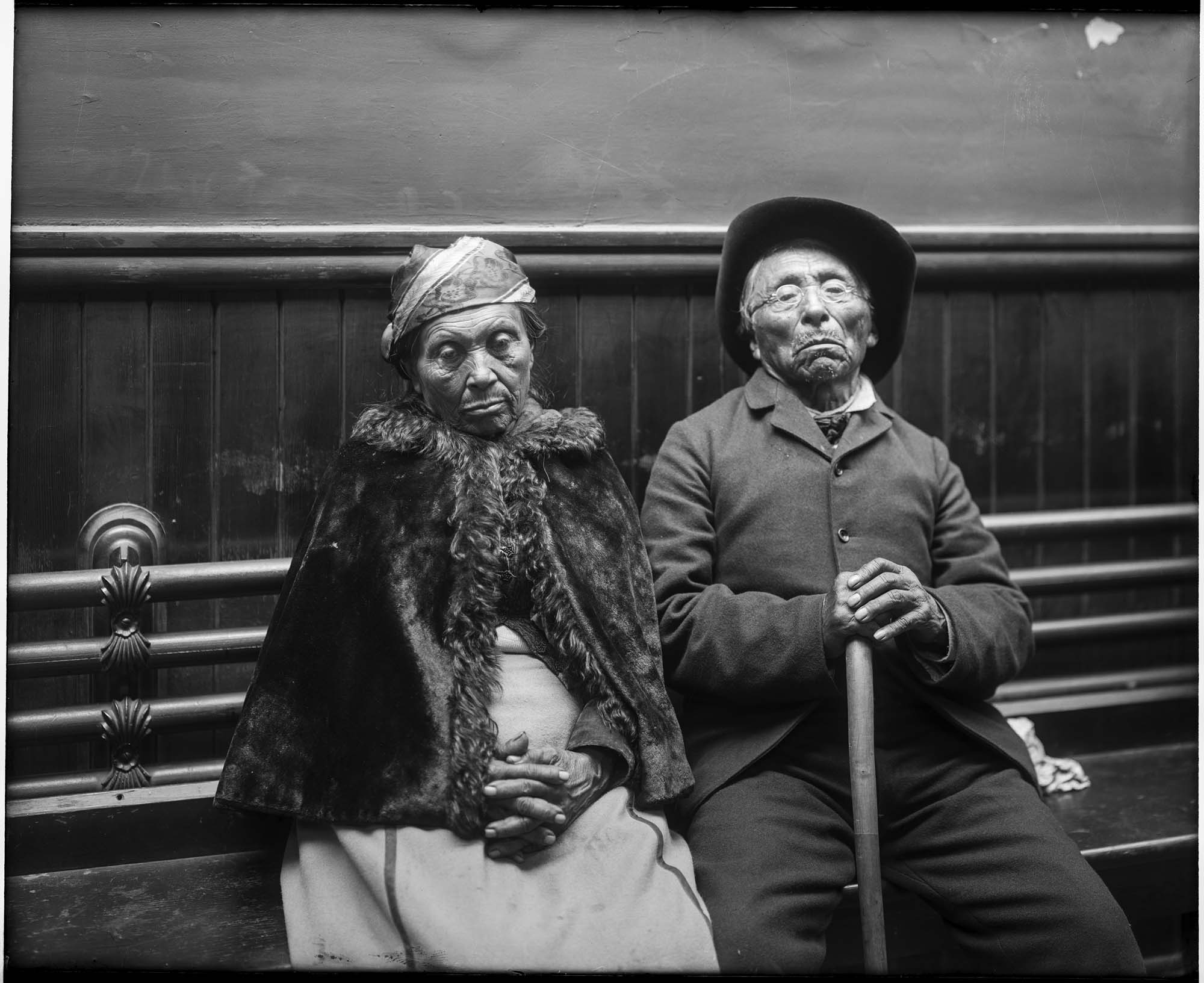 Image of Man and woman, possibly Suquamish, seated inside a Seattle building, circa 1910