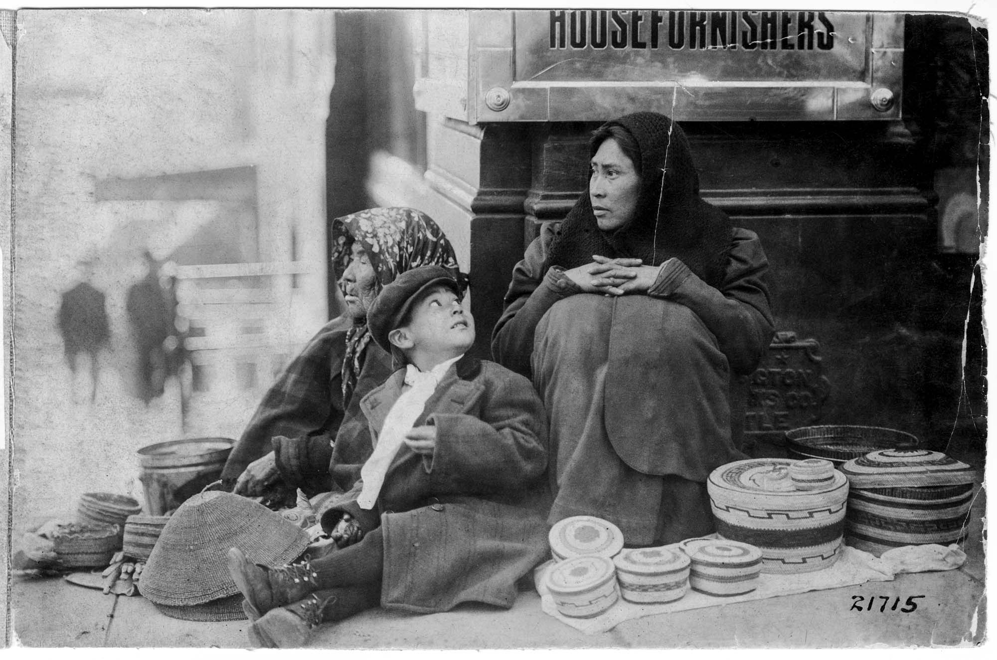 Image of Indigenous family selling baskets in downtown Seattle, circa 1912