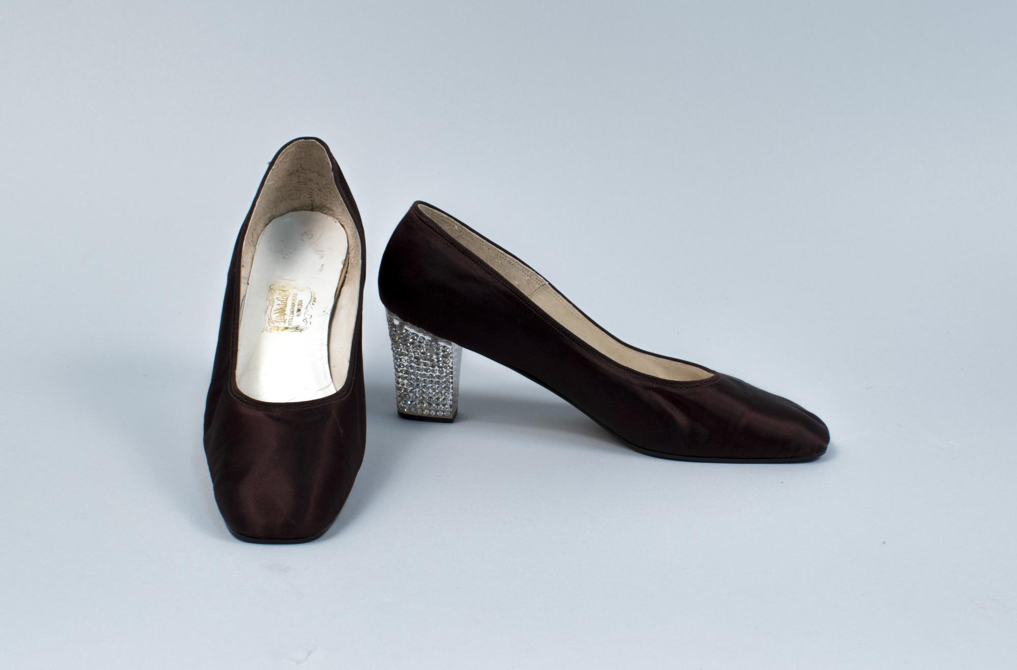 Image of Pair of brown pumps with rhinestone heels, ca. 1968