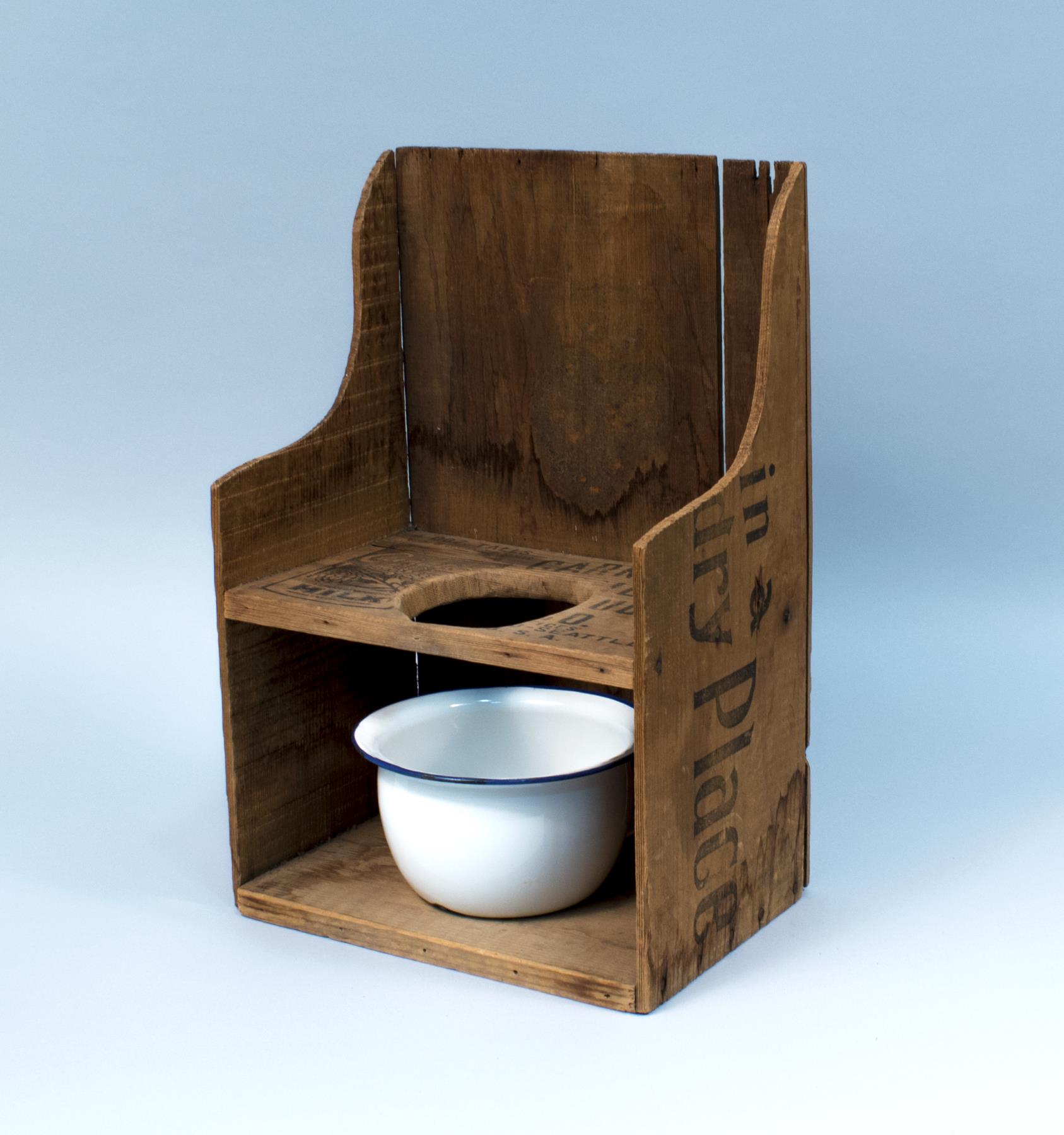 Image of Potty chair made from a Carnation milk crate, ca. 1910-1920