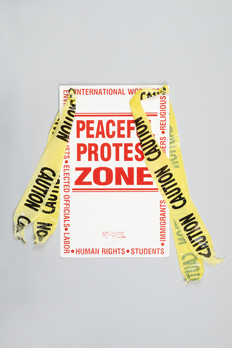 Image of Poster and yellow caution tape from the World Trade Organization (WTO) protest, 