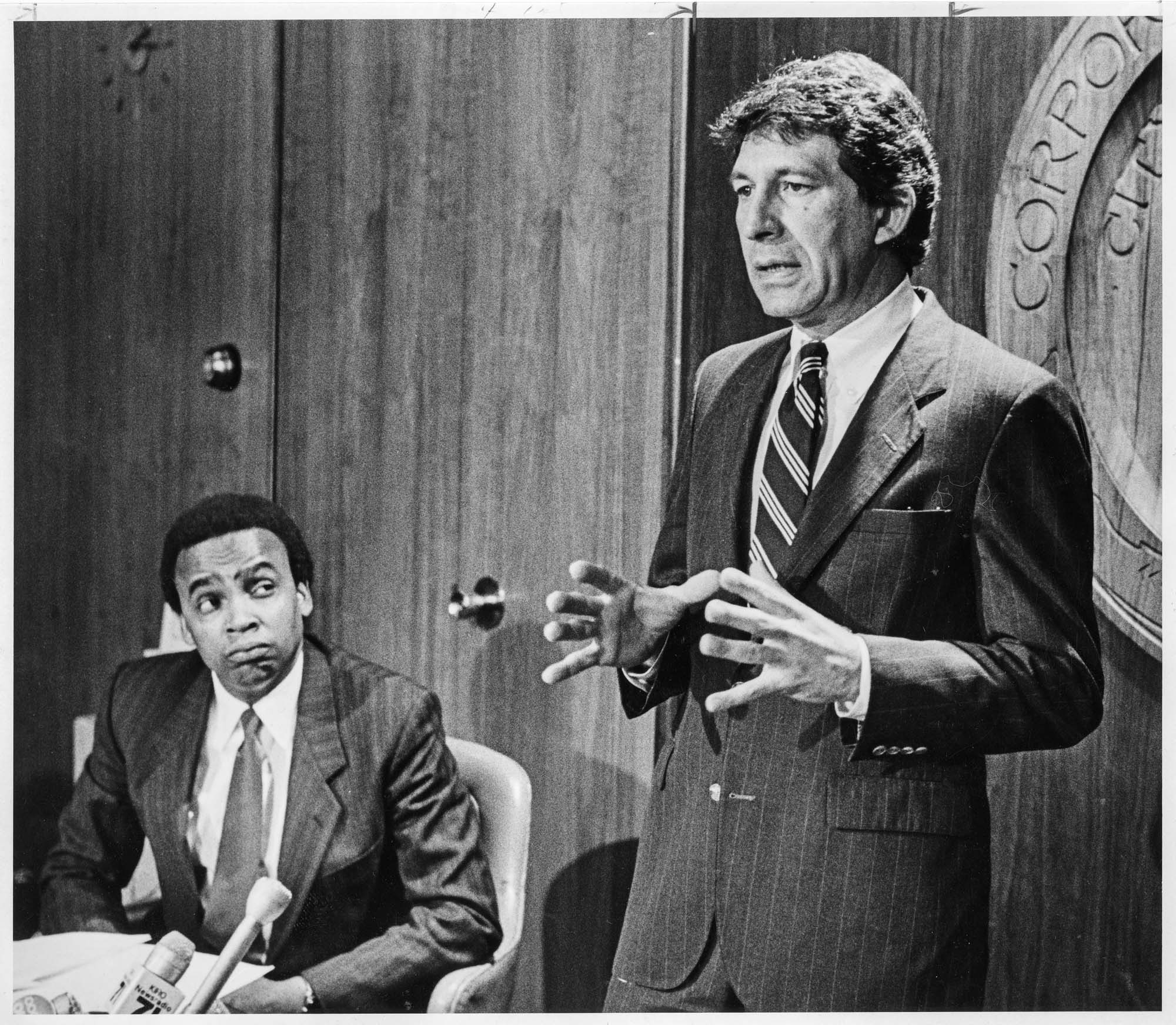 Image of Seattle City Council President Norm Rice listening to Mayor Charles Royer at Seattle City Hall, May 1, 1985