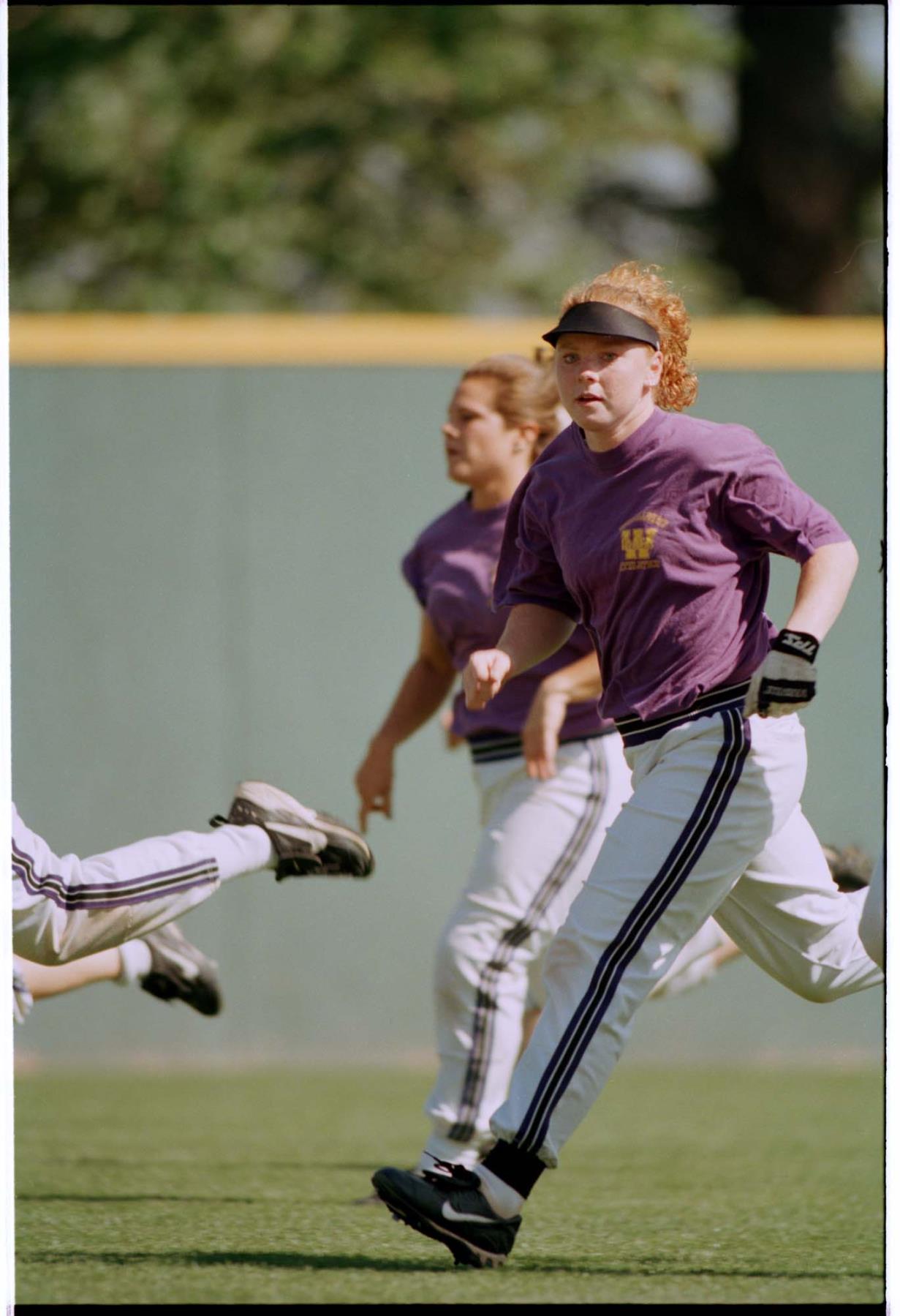 Image of Sara Pickering running off baseball field, Seattle, May 13, 1997