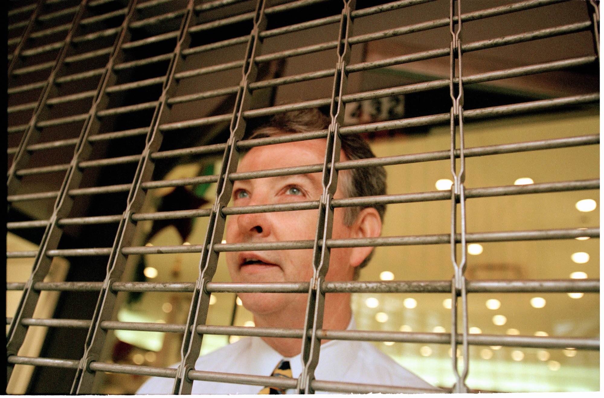 Image of Storekeeper behind security gate during WTO protests, Seattle, December 1, 1999
