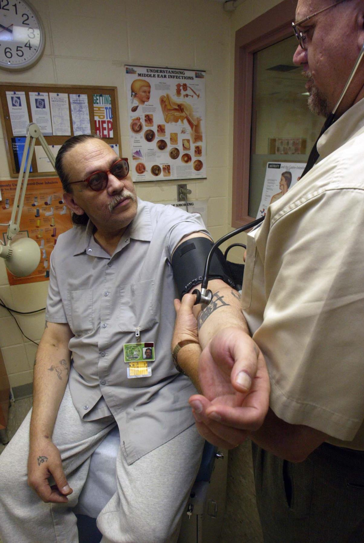 Image of Pierre Parent having his blood pressure checked at the Monroe Correctional Complex, August 14, 2002