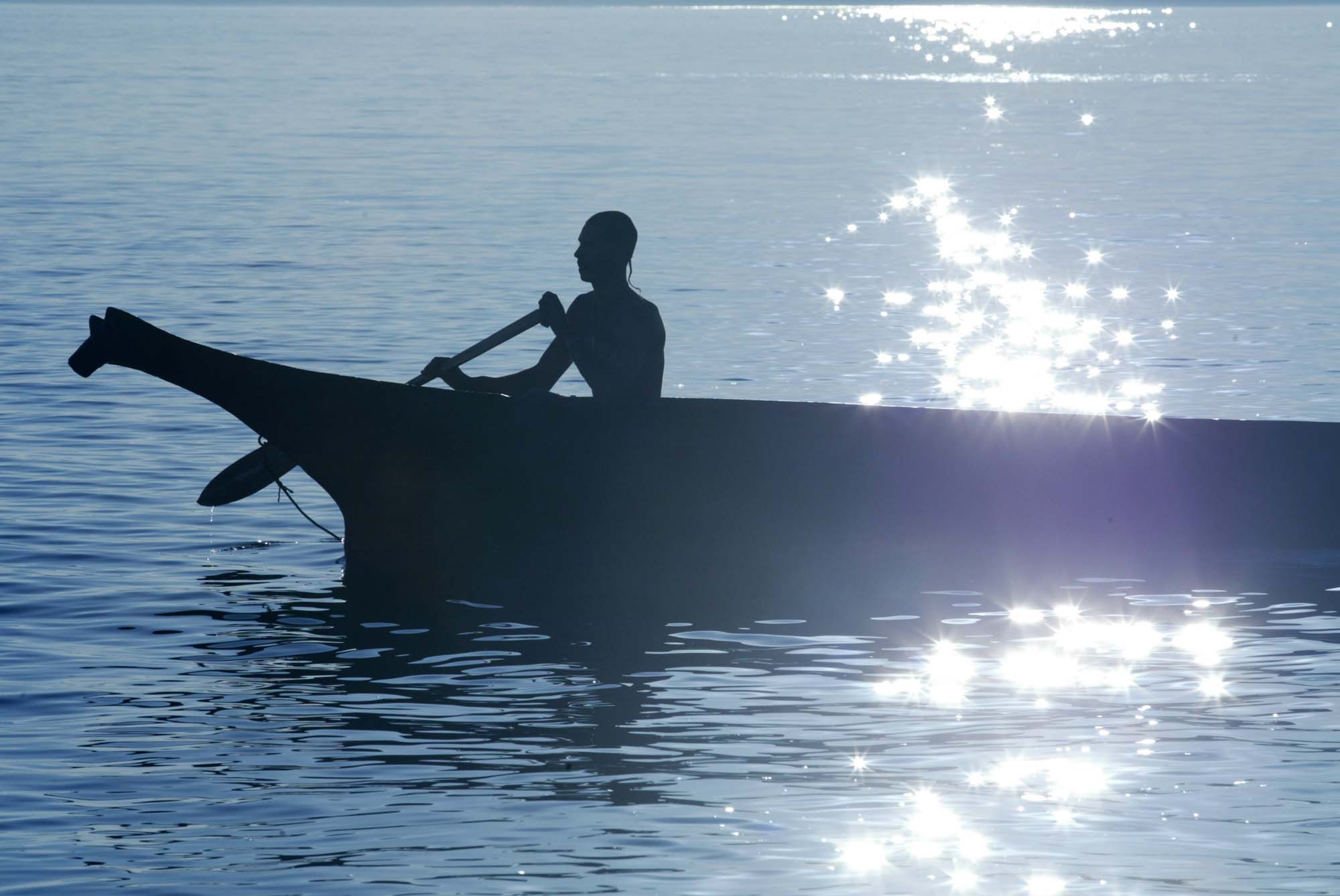 Image of Long Tall (Chippewa) paddling a traditional cedar canoe, Redondo Beach, August 2002