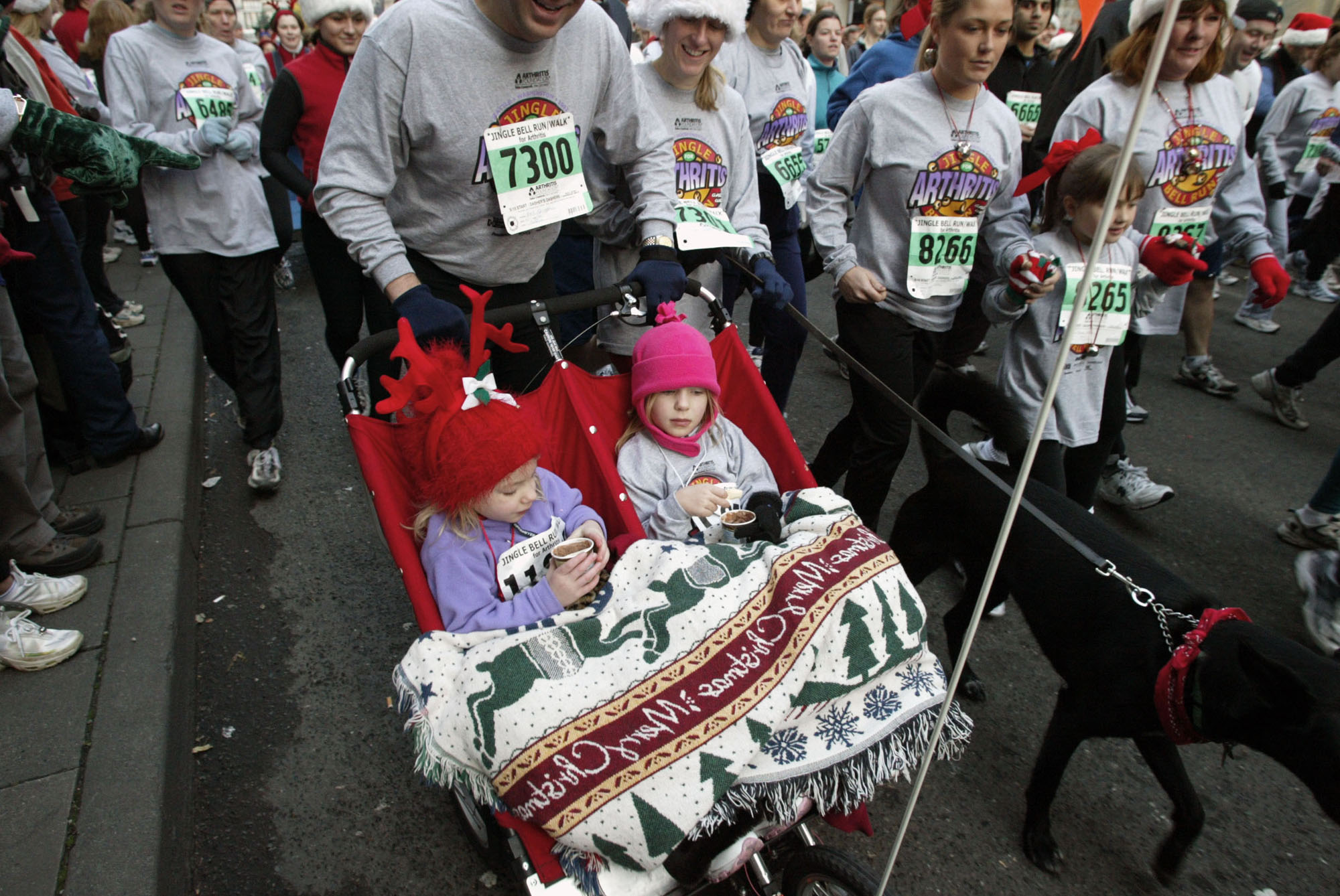 Image of Participants run and ride in the Jingle Bell Run fund raiser, Seattle, December 8, 2002