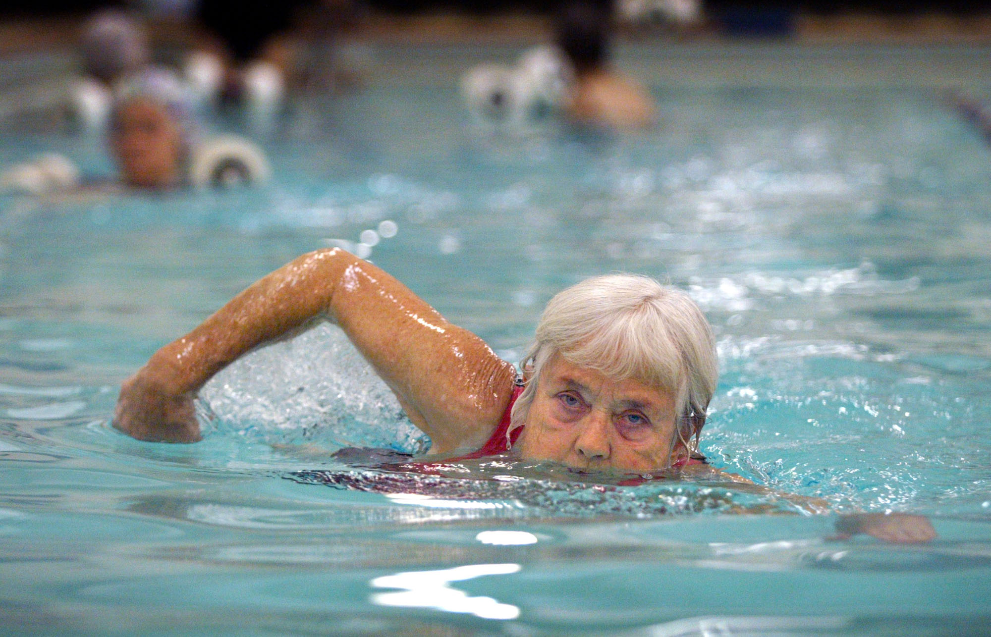 Image of Jeanne Wharnsby and others enjoying YWCA pool, Seattle, December 13, 2002