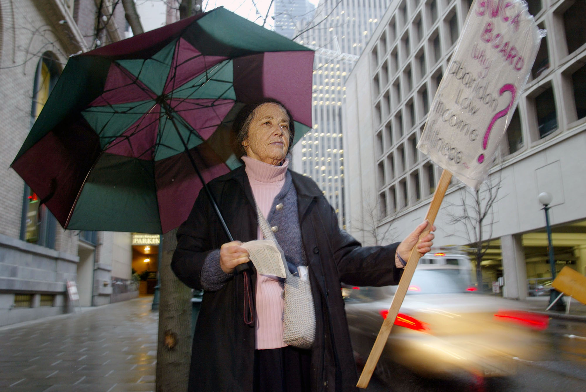 Image of Harriet Thompson picketing at entrance to YWCA, Seattle, December 13, 2002