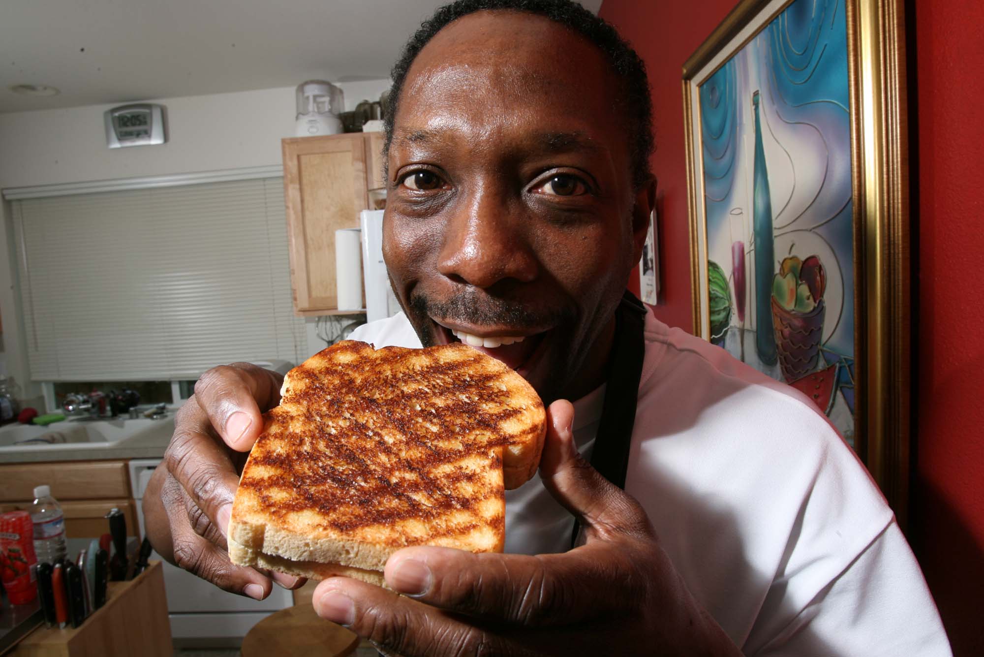 Image of Chef Wayne Johnson with a grilled peanut butter and jelly sandwich, Seattle, January 29, 2007